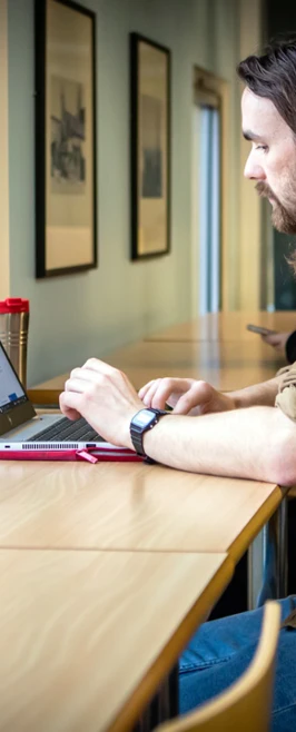 Student working on a laptop at a window-side desk in the Glasgow Kelvin College East End Campus library.  Student working on a laptop at a window-side desk in the Glasgow Kelvin College East End Campus library.